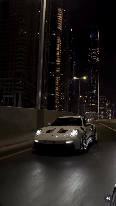 Porsche GT3 RS on a lit city road at night, from the ALADDIN Instagram reel