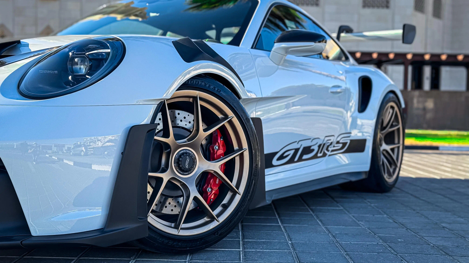 Porsche 911 GT3 RS showing the front wheel, headlight and side body detail