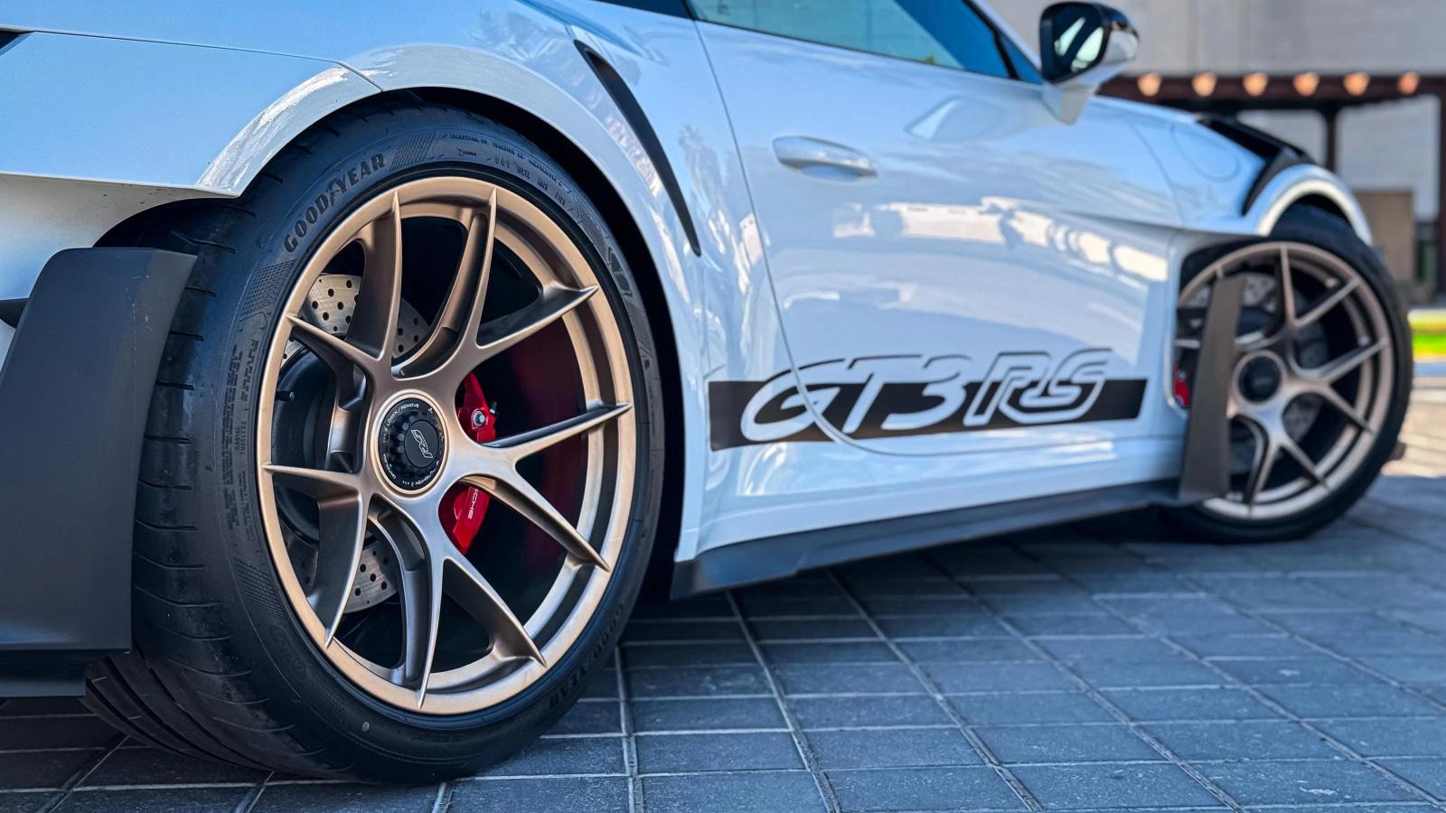 Porsche 911 GT3 RS showing the rear wheel and side body detail
